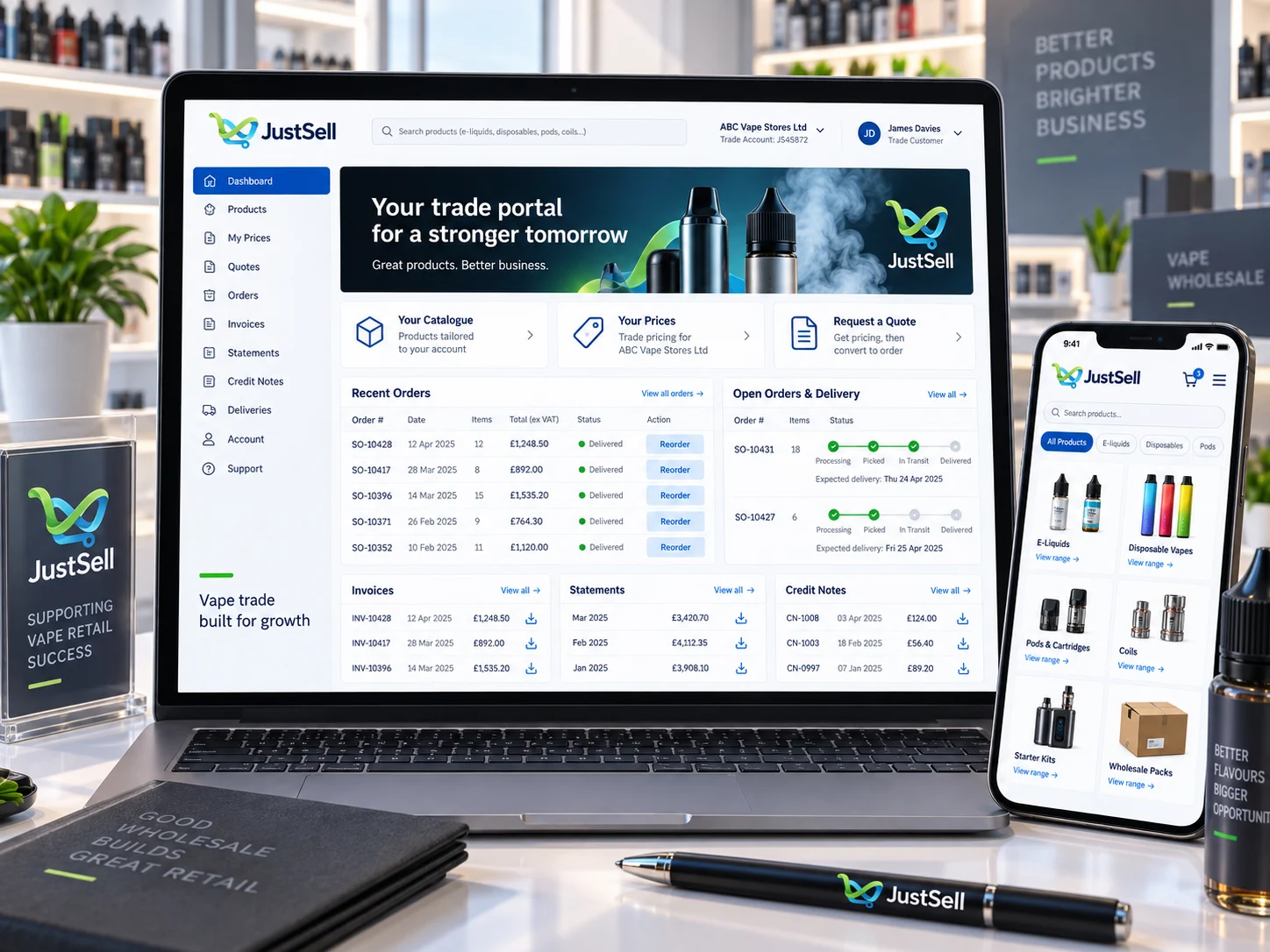 JustSell trade portal on a laptop and phone in a vape shop, showing recent orders with reorder buttons, invoices, statements, credit notes and open delivery tracking